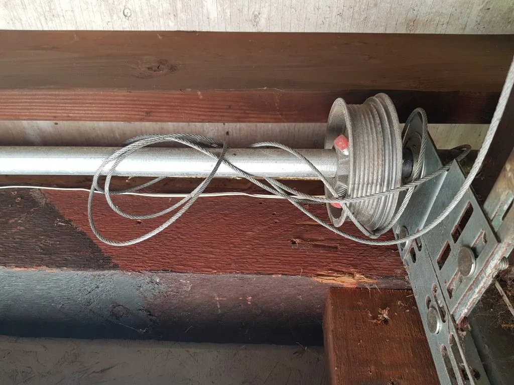 Garage door hanging uneven after coming off track