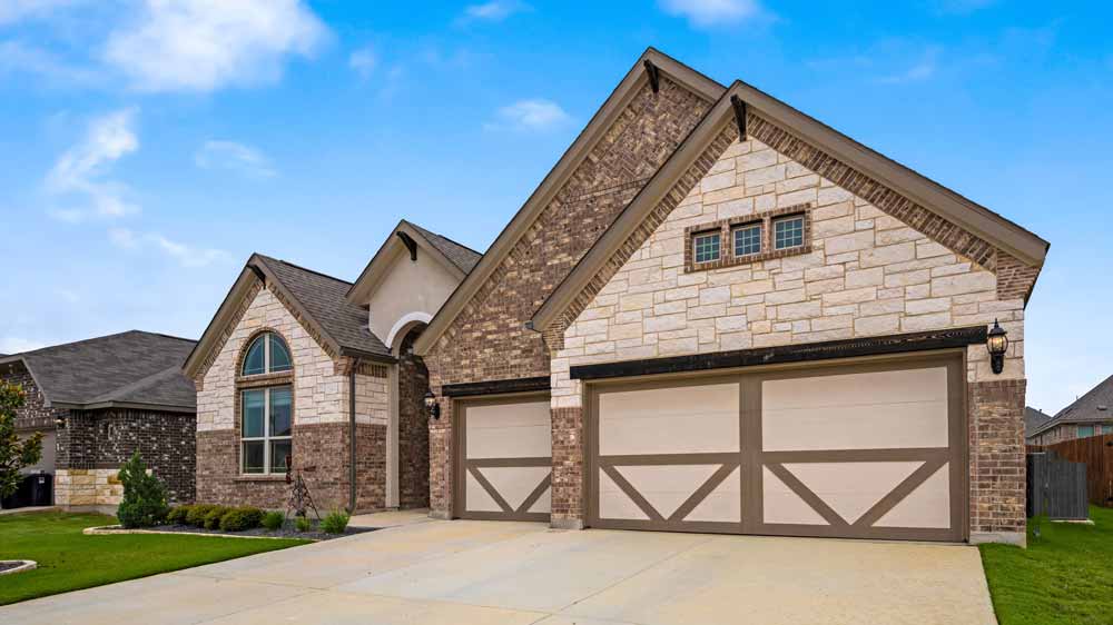 Texas home with a tan garage door in ZIP code 76021